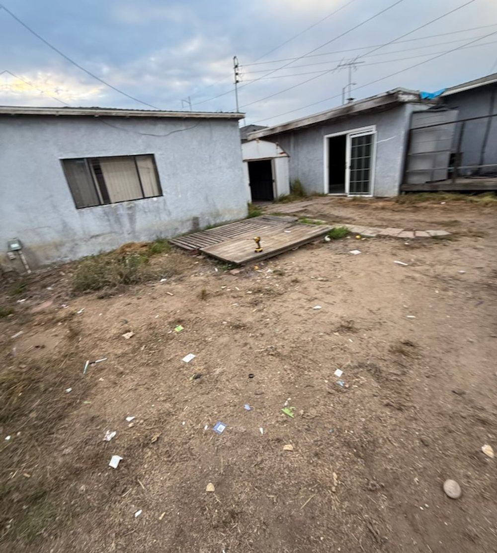 Backyard cleared down to bare dirt after yard waste removal