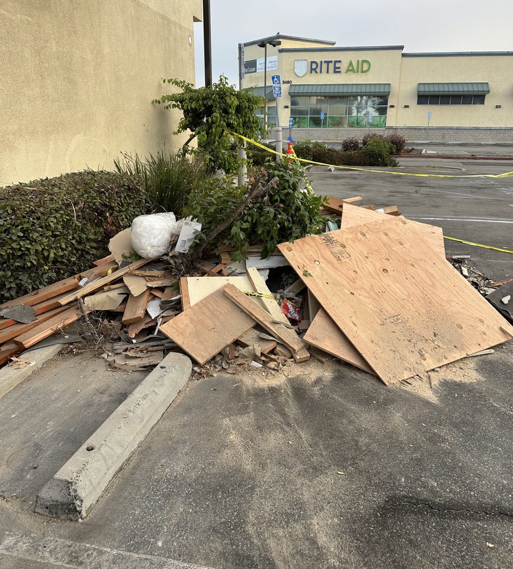 Construction debris and plywood piled outside a building