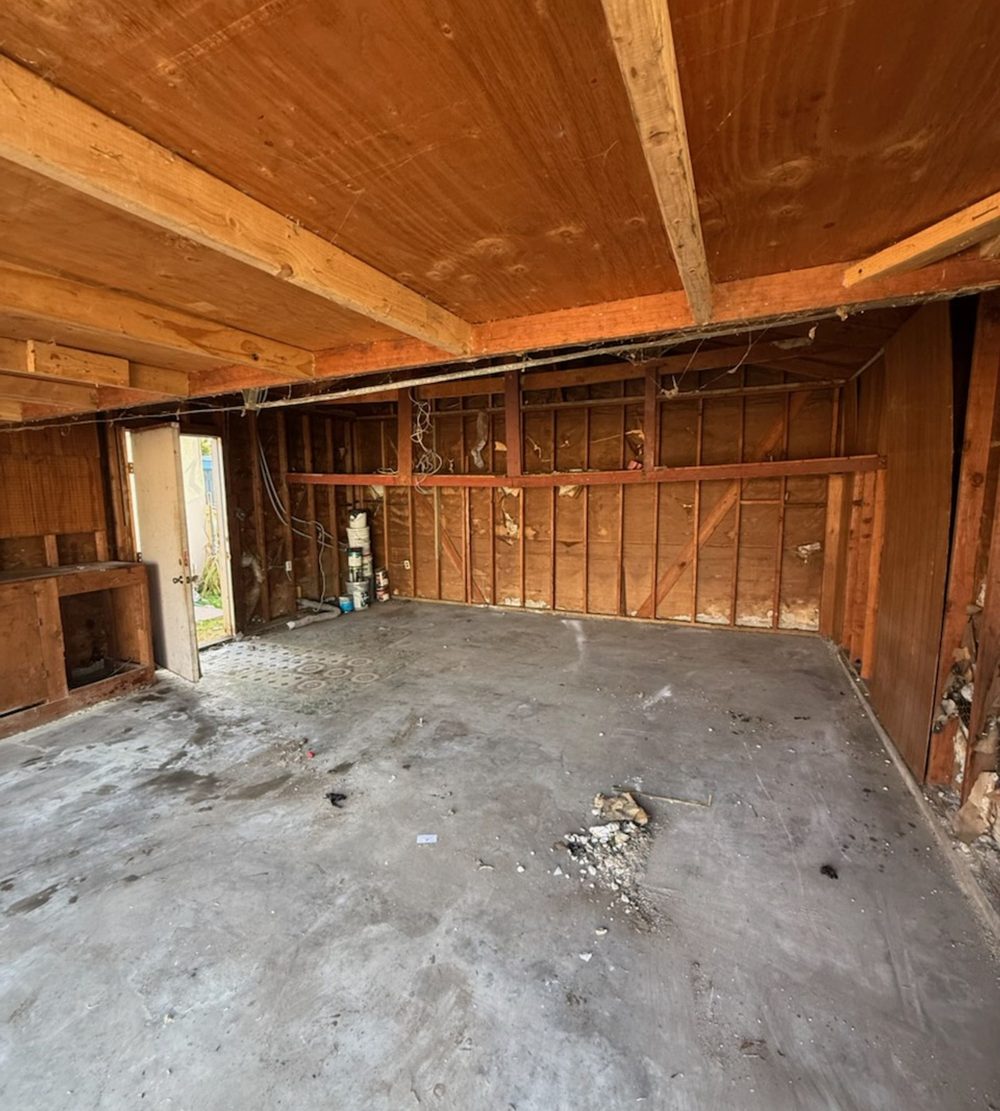 Empty garage with bare walls after junk removal
