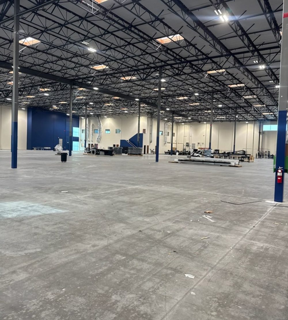 Empty warehouse floor after old equipment and boxes were removed