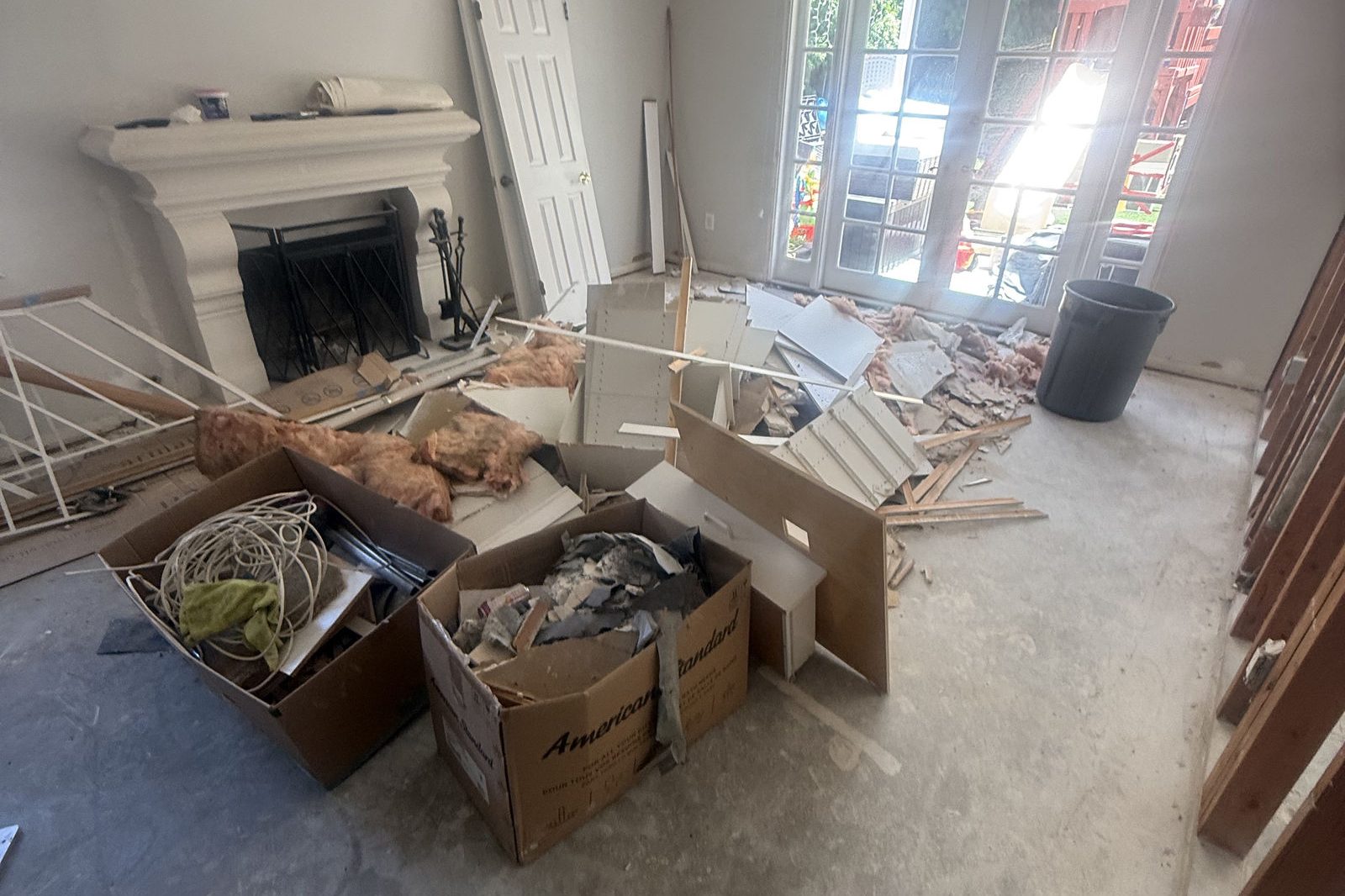 Living room full of boxes and clutter before a house cleanout