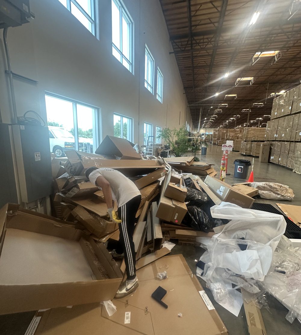 Office with desks, chairs and boxes being cleared out